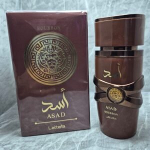 Perfume árabe Lattafa Asad Zanzibar para hombre en frasco color café con detalles dorados y caja original.