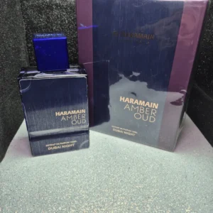 Perfume árabe Al Haramain Amber Oud Dubai Night en frasco azul oscuro con caja original.