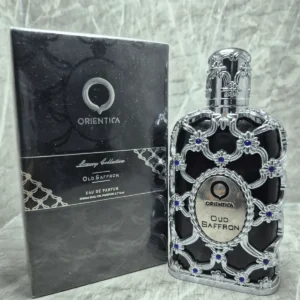 Perfume árabe Orientica Oud Saffron unisex en frasco negro con diseño de malla plateada y caja original.
