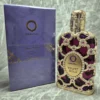 Perfume árabe Orientica Velvet Gold para mujer en frasco morado con diseño de malla dorada y caja original.